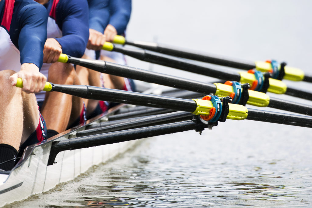Picture of men rowing together as a team