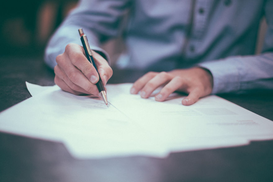 Picture of man holding a pencil and writing