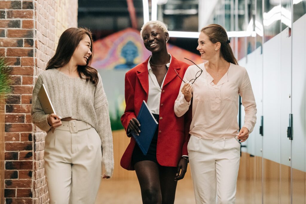 Three happy young women at the end of a successful group interview.