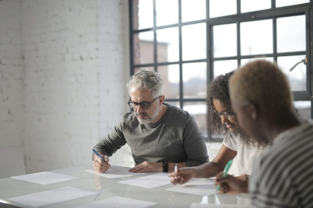 Three colleagues going over the results of a group interview.